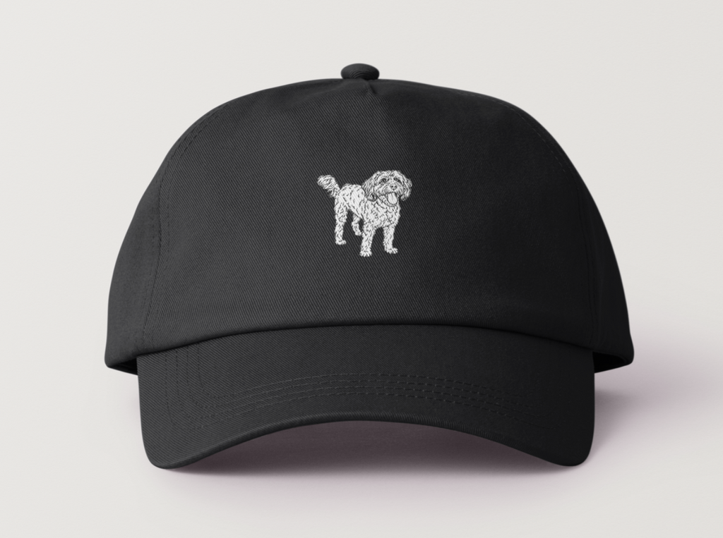 Front view of black cap with white embroidered Toto the Dog design